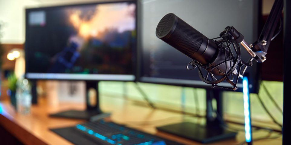 Gaming Computer Setup on Desk at Home with Microphone and Multiple Monitors