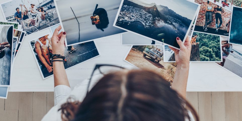 Photographer Looking at Prints in Studio